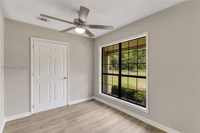 Unfurnished bedroom featuring light hardwood / wood-style floors and ceiling fan | Image 14
