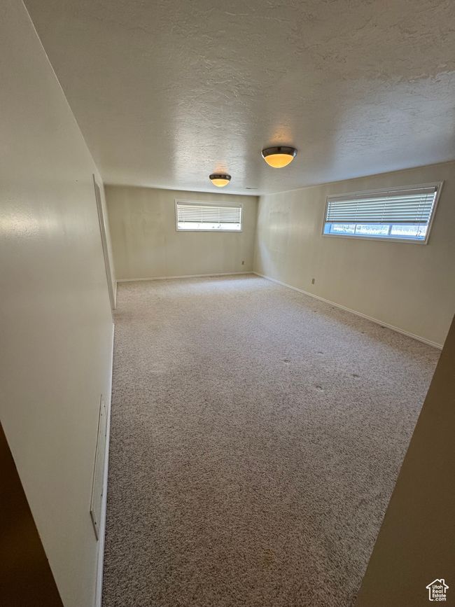 Unfurnished room with plenty of natural light, carpet flooring, and a textured ceiling | Image 14