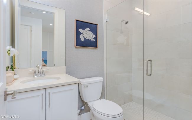 Bathroom with vanity, an enclosed shower, and toilet | Image 21