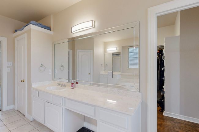 Full bath with baseboards, a spacious closet, vanity, and wood finished floors | Image 19