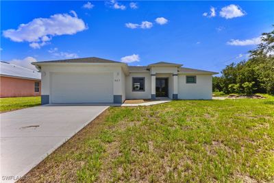 View of front of property featuring a garage and a front yard | Image 1