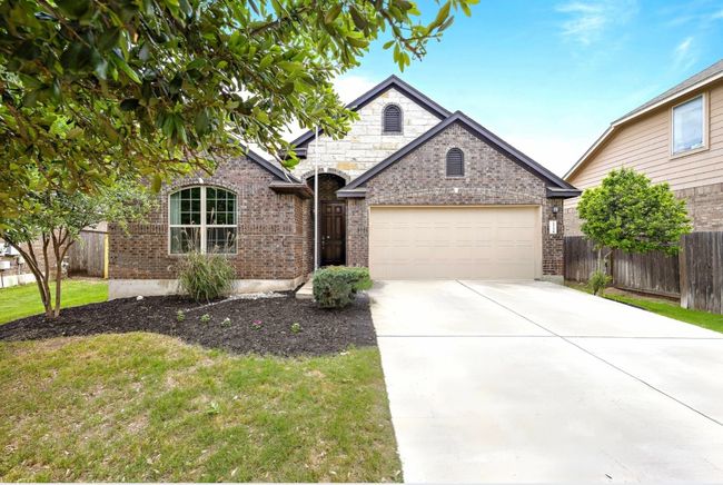 View of front facade with an attached garage, brick siding, and concrete driveway | Image 39