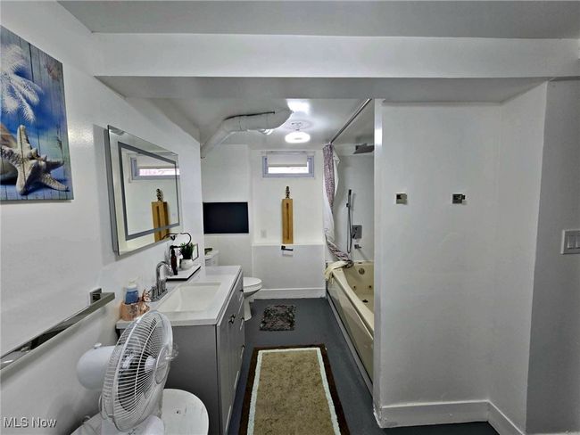 Full bathroom with baseboards, toilet, vanity, and shower / bath combination with curtain | Image 48