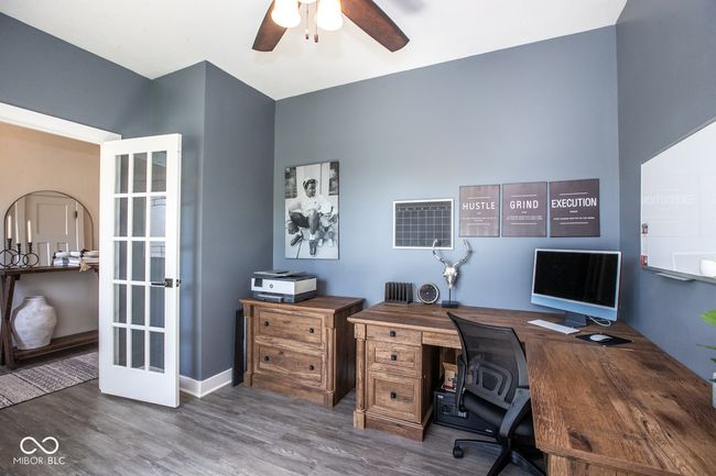 office area featuring a ceiling fan and wood finished floors | Image 7