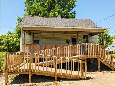 Front of the house with wooden steps and ramp. | Image 1