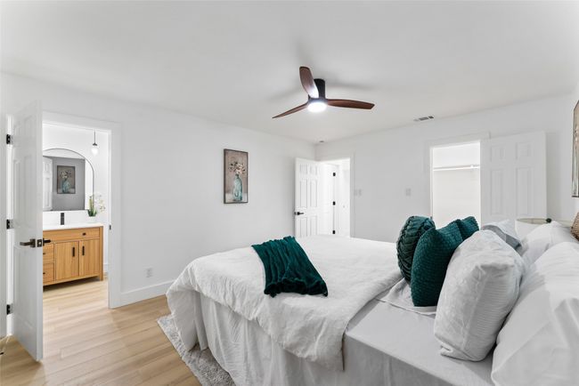 Bedroom featuring light wood-type flooring, ceiling fan, and ensuite​​‌​​​​‌​​‌‌​‌‌​​​‌‌​​‌‌​‌​​​​​‌ bath | Image 13