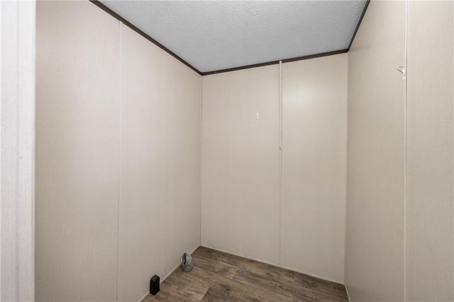 Spare room featuring wood finished floors and a textured ceiling | Image 24