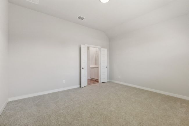 Spare room with light colored carpet, lofted ceiling, and baseboards | Image 9