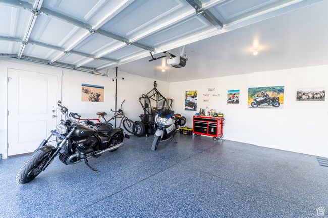 Garage with baseboards and a garage door opener | Image 19