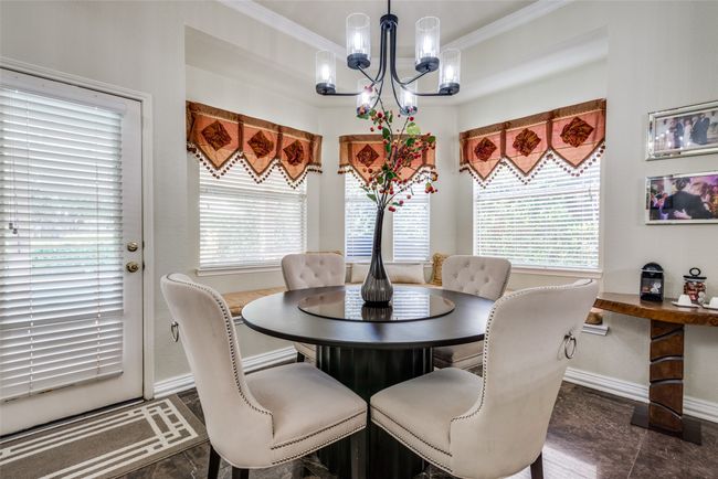 Breakfast area has an adorable corner window seat. | Image 13