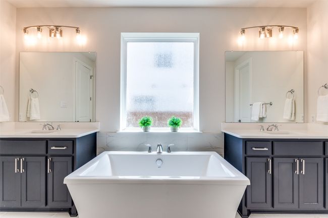 Bathroom featuring two vanities and a freestanding bath | Image 21
