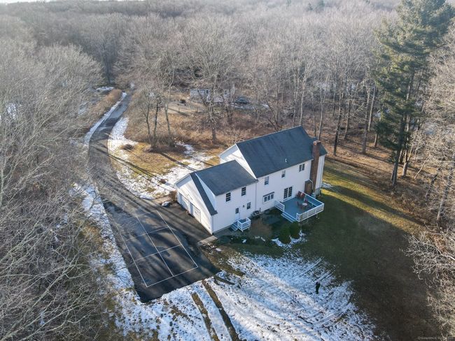 Aerial photo showing the back of house, surrounding yard. NOTE: the pickleball court lines in the driveway. | Image 33
