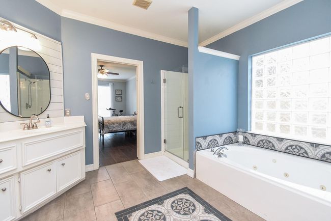 Your 10' x 13' en-suite bathroom is spacious - with double sinks, huge mirrors, cultured marble counters and plenty of cabinets and drawers to store away all your personal items. Note that your primary bathroom was remodeled 2021! | Image 15