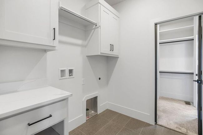 Laundry room featuring cabinet space, hookup for a washing machine, hookup for an electric dryer, and baseboards | Image 25