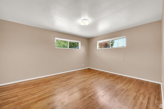 Spare room with baseboards and light wood-style flooring | Image 11