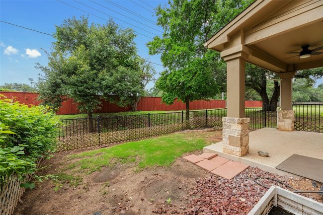 Fenced backyard with a ceiling fan | Image 27