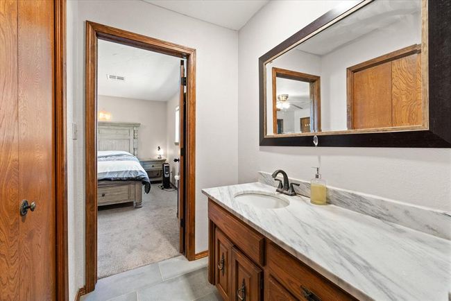 Bathroom with ensuite bathroom, vanity, ceiling fan, and tile patterned flooring | Image 24