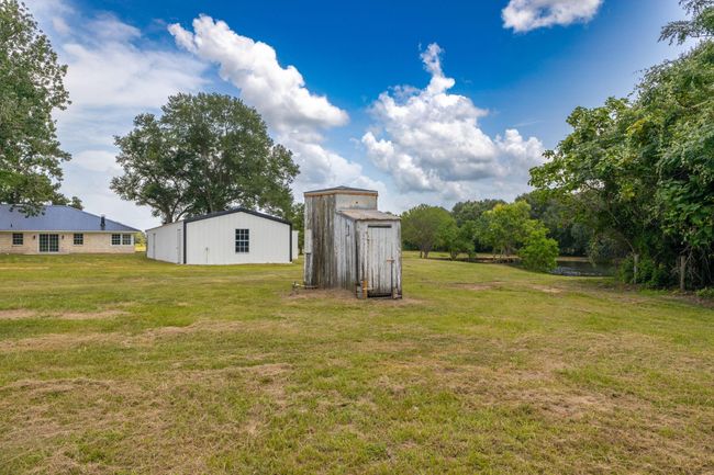 Charming property featuring a functional antique water well and a spacious workshop, perfect for hobbyists and those seeking a touch of history. | Image 43