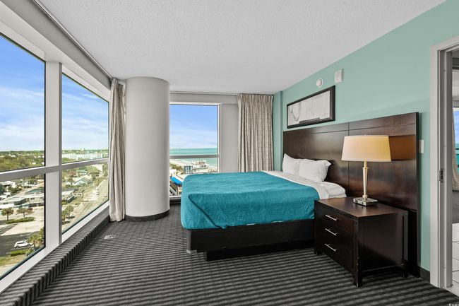 Bedroom featuring carpet floors and a textured ceiling | Image 24