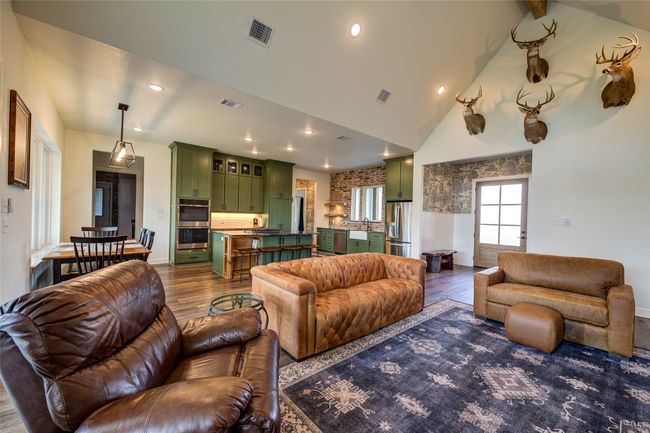 Living room featuring high vaulted ceiling, sink, and dark wood-type flooring | Image 6