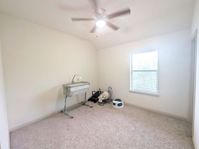 Carpeted spare room with ceiling fan and vaulted ceiling | Image 31