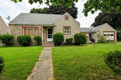 View of front of house with a garage and a front lawn | Image 1