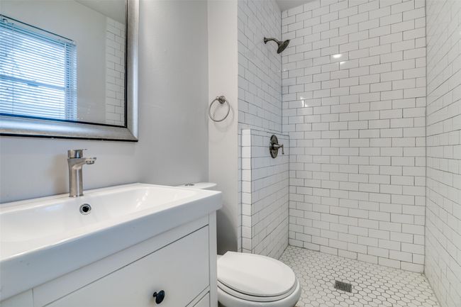 Full bath featuring toilet, a stall shower, and vanity | Image 18