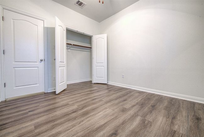 Unfurnished bedroom featuring wood finished floors and a closet | Image 15