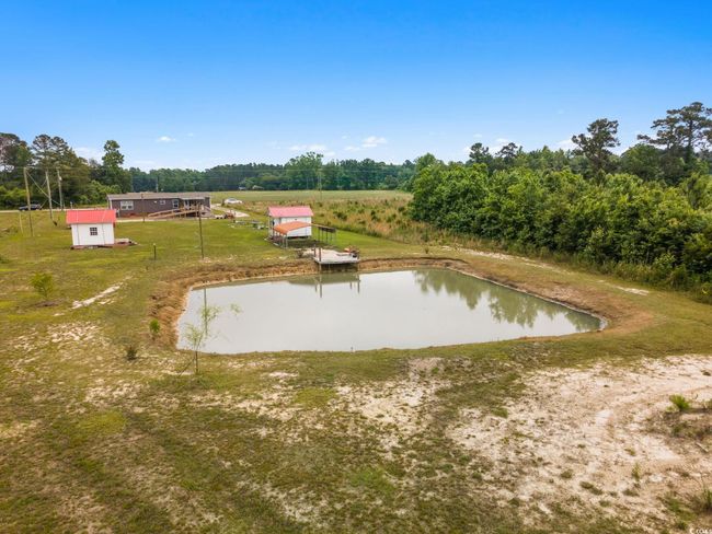 View of storm shelter featuring a water view and a lawn | Image 6