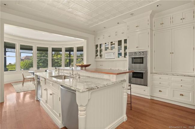 KITCHEN // Thermador appliances include commercial cooktop, double oven, warming drawers, Sub-Zero, 2 dishwashers - Miele and Bosch, 2 sinks, walk in pantry, butler�s pantry with sink and Marvel wine cooler and office alcove with built-ins. | Image 8