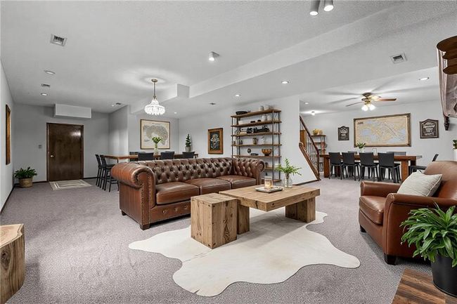 Living room featuring carpet floors, stairway, visible vents, and recessed lighting | Image 22