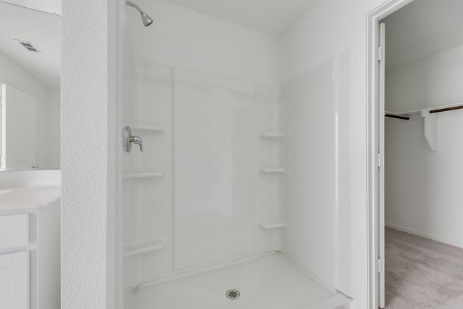 Full bath with a shower, a walk in closet, and vanity | Image 23