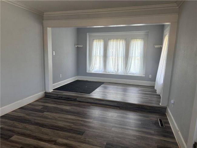 Empty room with ornamental molding and dark wood-style floors | Image 5