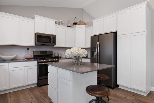 (Photo of decorated model, actual home's finishes will vary) High ceilings create a dramatic impact in the main level, and there are tons of windows bringing in natural light! | Image 8