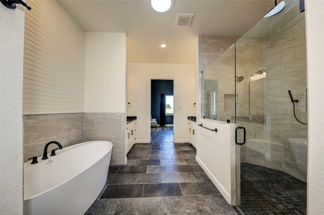 Bathroom featuring tile flooring, shower with separate bathtub, and vanity | Image 16