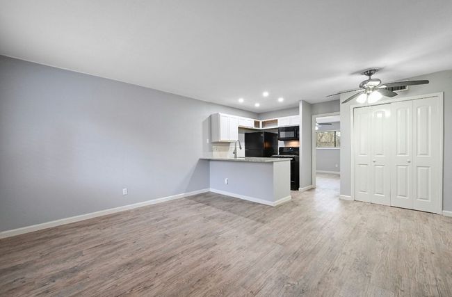 Unfurnished living room with light wood-style floors, a ceiling fan, and recessed lighting | Image 6