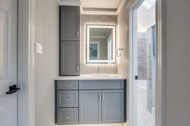 Bathroom featuring crown molding, vanity, and a bathtub | Image 22