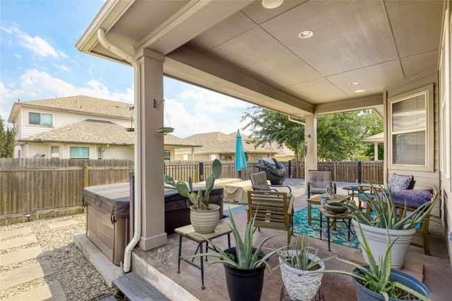 Fenced backyard featuring a hot tub, a patio area, and an outdoor hangout area | Image 22