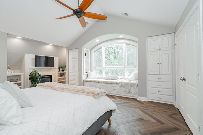 Bedroom featuring ceiling fan, a fireplace, high vaulted ceiling, recessed lighting, and visible vents | Image 19