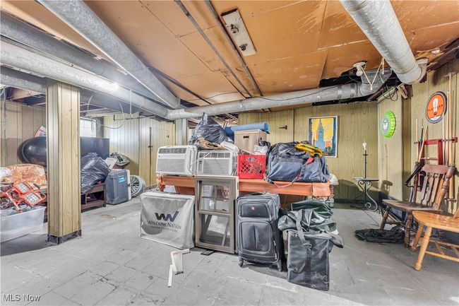 Unfinished basement featuring wood walls | Image 23