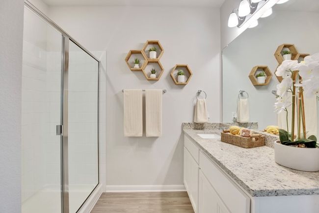 Bathroom featuring vanity, a stall shower, and wood finished floors | Image 6