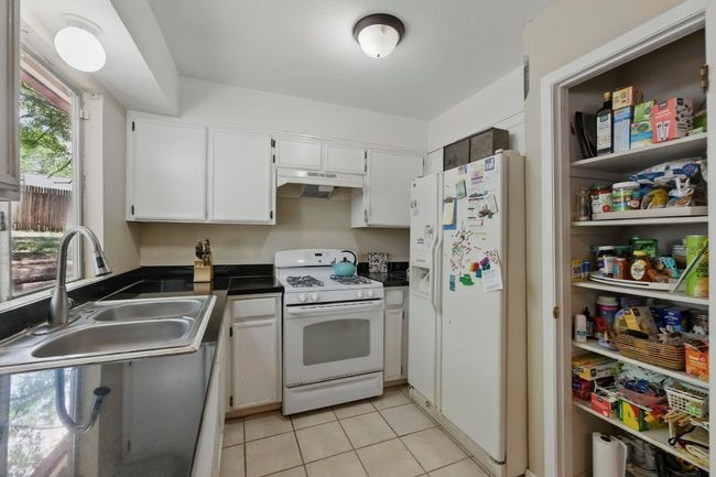 Kitchen has a large pantry. | Image 9