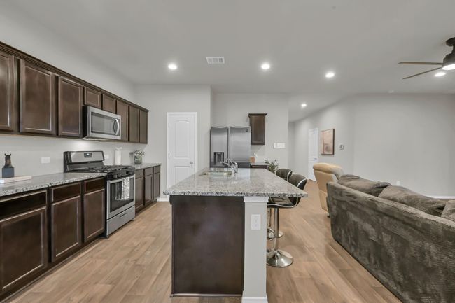 Welcome to your future kitchen. Warm cabinetry, abundant granite countertops, and stainless steel appliances offer timeless appeal. | Image 10