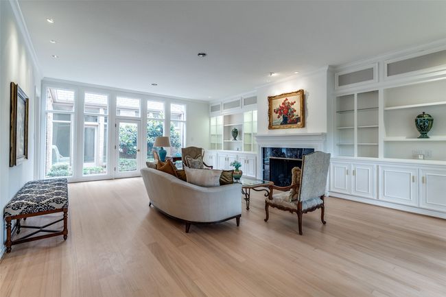 Living room featuring crown molding, a fireplace, light wood finished floors, built in features, and recessed lighting | Image 4