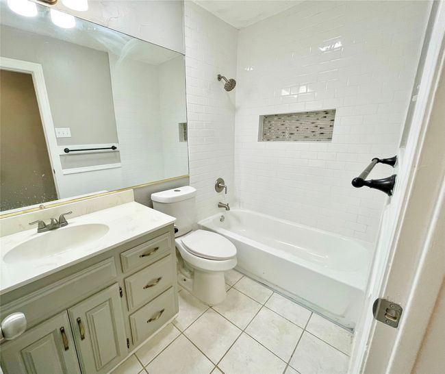 Bathroom featuring vanity, shower / washtub combination, toilet, and tile patterned flooring | Image 8