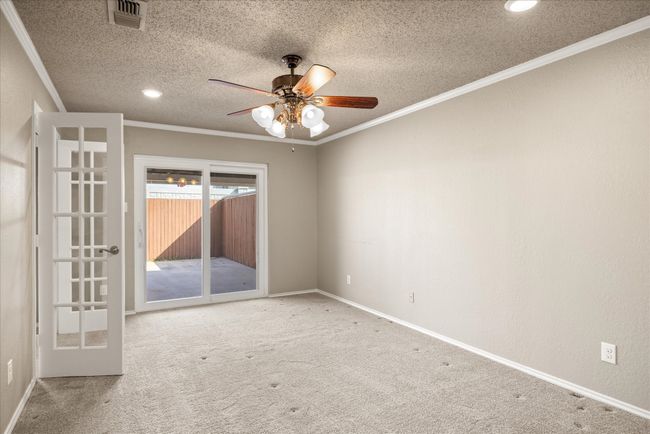 Primary Bedroom ceiling fan, walk-in closet and access to coverd back courtyard. | Image 18
