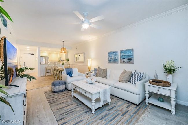Living room is open to the kitchen and dining area | Image 7