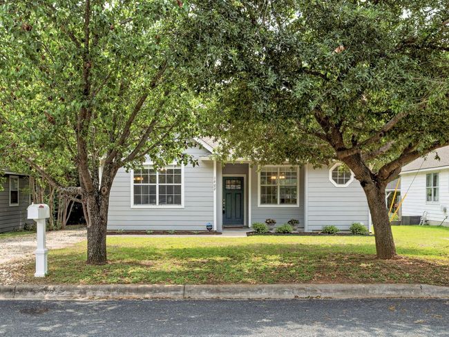 View of property hidden behind natural elements with a front lawn | Image 37