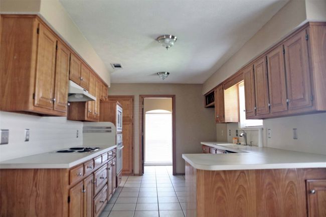 Kitchen with healthy amount of natural light, a sink, and light countertops | Image 5
