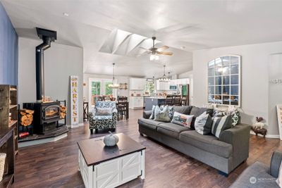 Great room with wood burning stove, skylights and Hickory flooring that runs throughout the entire home. | Image 3